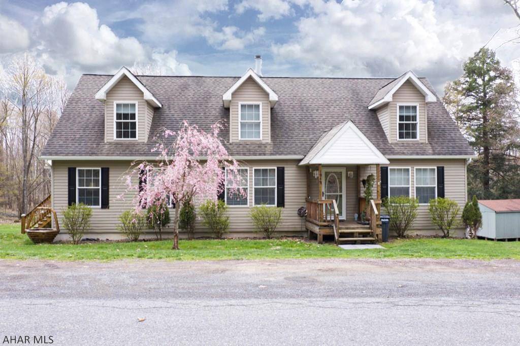 Welcome home to this charming cape cod that sits on over an acre! Featuring 3 bedrooms, 2 full baths, 1st floor master, 1st floor laundry, a wood burning fireplace, and a kitchen that is open to the dinning room, this home has so much to offer. Full unfinished basement with walk out double doors makes for an ideal storage space.  Enjoy spending time on the new, huge, wrap around covered deck! The roof covering the deck is metal and the wood was just stained this past year. Workshop/shed can also be used for storage!