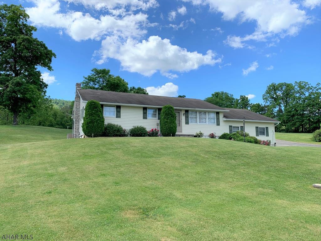 Very well maintained ranch home in Snake Spring Valley!! This home offers a living room with picture window, kitchen open to the dining area, large rear sun porch, three bedrooms, one full bath and laundry room on the main level. Full basement with half bath, updated oil hot water furnace, central air-conditioning, 200-amp electric, private well and private septic. Pull down attic stairs and floored attic for storage. Two-car attached garage, one-car detached garage with electric, outbuilding, and a fenced pasture area. Great location with large 1.85 acre lot. Enjoy the scenic country views from your own property!!!