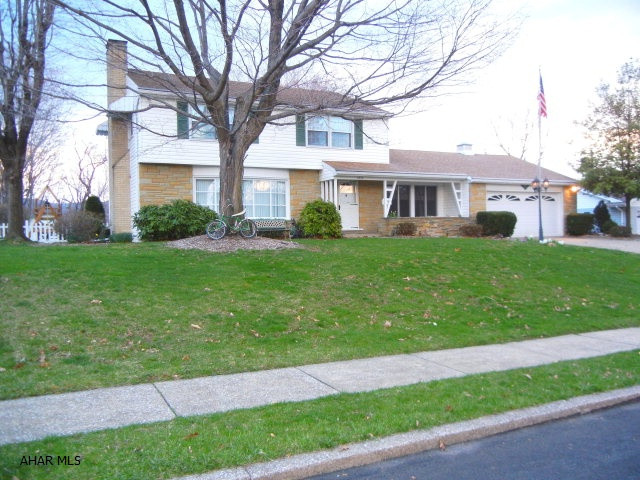 Spacious vinyl sided home in Highland Park.  Cherry kitchen with appliances, Italian marble tile fireplace in living room, wood burning fireplace in FR, hardwood floors, cedar closet. Outside exit from basement.  Stone patio with firepit.  Former bath house has electric, water, gas, and previously had toilet.  Garden area.  Vinyl fencing.  Cement driveway.  Taxes are flat rate and do not include Homestead Tax deduction.
