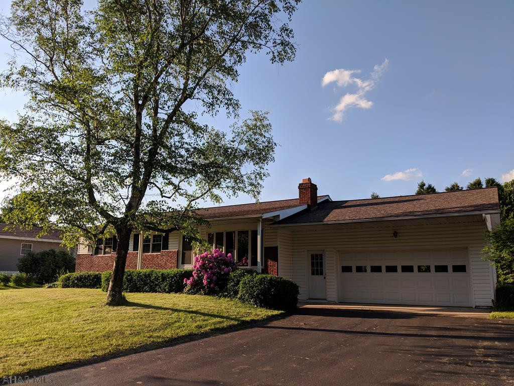 Ranch style brick & vinyl home with great yard space, flat back yard, covered patio & plenty of potential! Step inside to find a freshly painted living room with a beautiful bay window to bring in lots of light. This room features a brick wall with built in fireplace. The kitchen has a double oven, gas cook top and lots of cabinet space. Another show piece of this home is the large sunken family room. Wood on the ceiling gives it a log cabin feel and the fireplace adds coziness to the space. The master bedroom has a full bath and is located off the family room. All bedrooms are on first floor. One has laundry hook ups in case you prefer first floor laundry. Other hook ups are in basement where there is ample storage. Two car garage too!