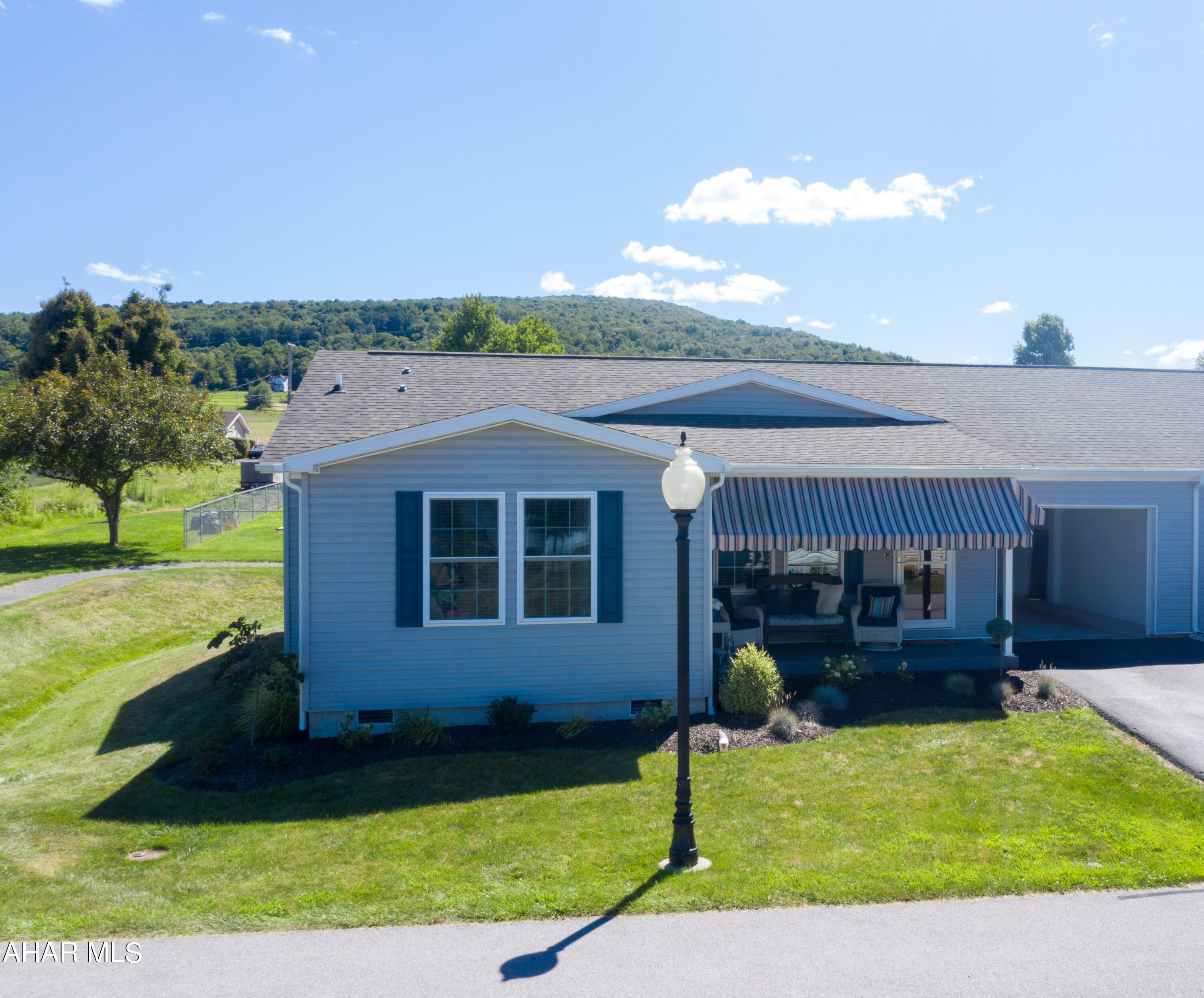 One story living in the gated Deer Meadow Community.  This is a 55 and older community in Hollidaysburg with so much to offer!  The home has plenty of updates throughout including vinyl plank flooring, extra overhead lighting, granite countertops, and custom backsplash in the kitchen.  The kitchen has extra cabinets and a built in desk area.  The two bedrooms have custom closets and the primary bedroom has an en-suite bath.  There is a second full bath as well.  The laundry room features stackable washer and dry with extra storage cabinets.  One car garage with storage racks.  Epoxy / urethane front porch and privacy fence behind house.  HOA fee is $220 a month and covers exterior maintenance (siding, roof, etc), insurance, grass and snow removal, and access to common areas - club house and saltwater pool!