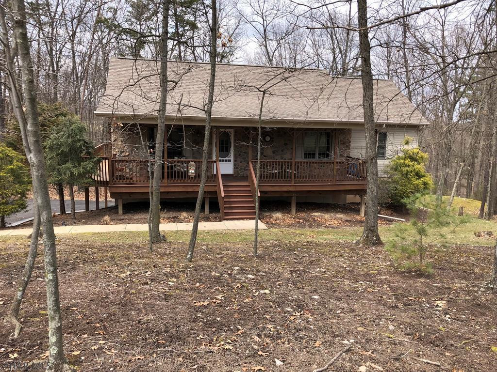 Enjoy this well kept ranch home in Lakeland Pines! Lakeland Pines is a well sought after neighborhood due to its close proximity to Lake Raystown, Seven Points Marina, & the Allegrippis Bike Trail. At Lakeland Pines you can enjoy the neighborhood trails, the catch & release pond, gazebo & much more. Two of the 3 bedrooms in this adorable ranch home have sliding doors that lead right on to the 16' X 24'4 deck to catch the beautiful views of the wooded back yard. With an eye catching stone fireplace and great views this home is a must have! Along with the finished basement and integral garage, this ranch also has a spacious workshop measuring 18'X12'. The master bedroom has a nice size walk in closet and master bath with a separate jacuzzi.