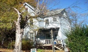 3 BR, 1 BA, 2.5 story home with extra lot on either side. Appliances included. Fenced yard. Needs TLC.