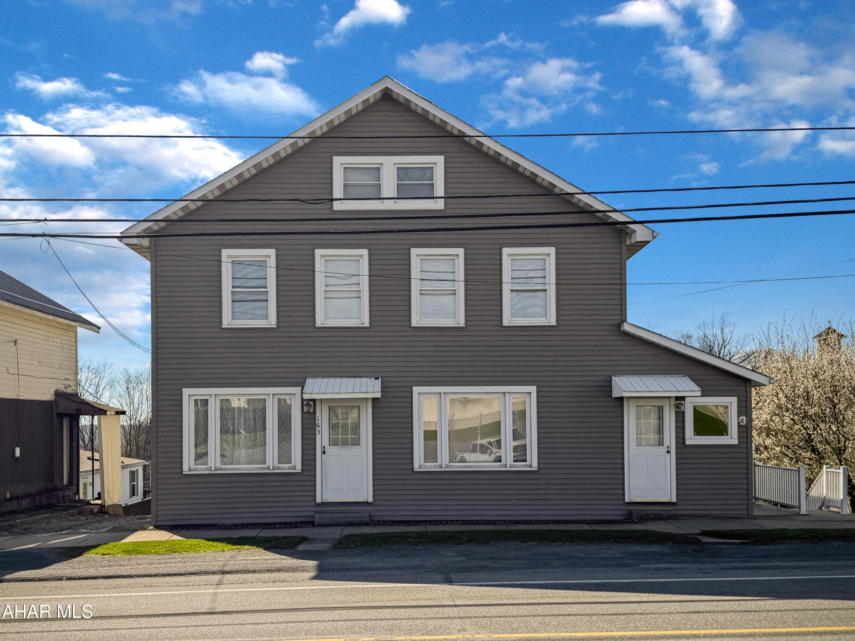 Welcome to 163 S Main Street in Carrolltown Borough - a unique property offering both residential and commercial possibilities. Previously used as a mixed-use residence, the main floor operated as a barber shop while the upper level served as a full living space. With two clearly divided areas, this property offers excellent flexibility for a two-unit conversion, live/work setup, or spacious single-family home. Even better, Carrolltown Borough has no zoning, opening the door to a variety of potential uses. The main level features a former barber shop with waiting area, large foyer, first-floor bedroom with closet (or bonus room), full bathroom, kitchen with laundry hookups, and a comfortable family room. Upstairs you'll find three nicely sized bedrooms, a large living room, full eat-in kitchen, and another full bathroom. The walk-up attic provides ample storage and potential for future expansion, while the unfinished basement offers additional storage space. Outside, the property boasts a newer shingle roof, updated siding and windows, composite decking, a spacious yard, under-porch storage, and more. This versatile property is packed with opportunity. Schedule your showing today!