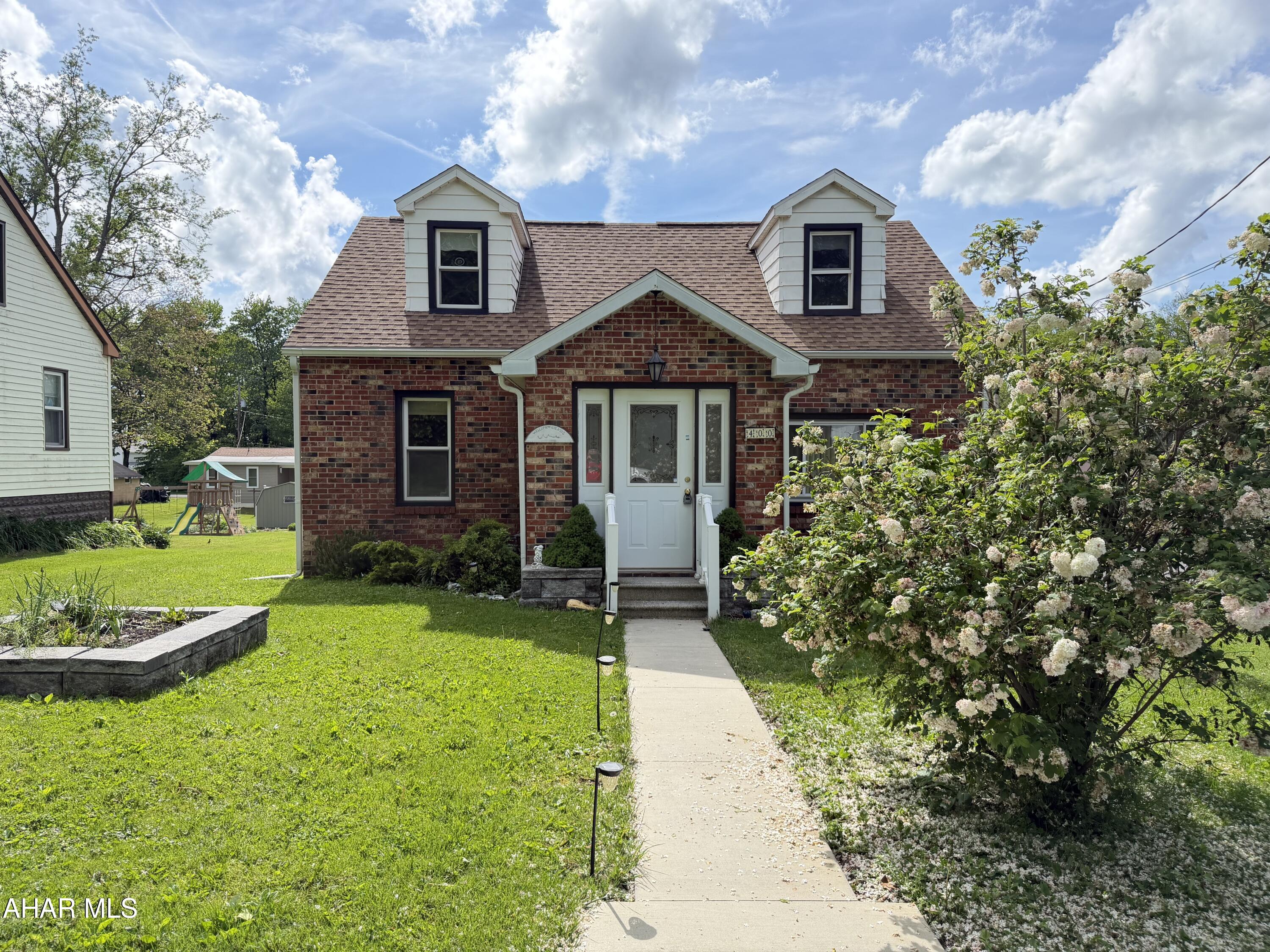 Welcome home to this charming Cape Cod style house! It sits on a beautiful corner lot in a low traffic area and is ready for you to move right in.  The spacious living room has large windows allowing natural light to flow in. The living room dining area make it the ideal space for entertaining family and friends.  The kitchen has plenty of cabinets for storage and features a large counter top for meal prep that doubles as an eating area.  All the appliances are included. There is a first floor bedroom and a full bath that complete this floor.  Upstairs, you will find two spacious bedrooms with newer flooring and plenty of closet space. The basement has an upgrade to the Pittsburgh toilet with a 3/4 bath and a laundry area.  Outside you will find a large deck to enjoy in the summer and a garage for covered parking in the winter. With a newer roof offering peace of mind, call today to see what this great home has to offer!