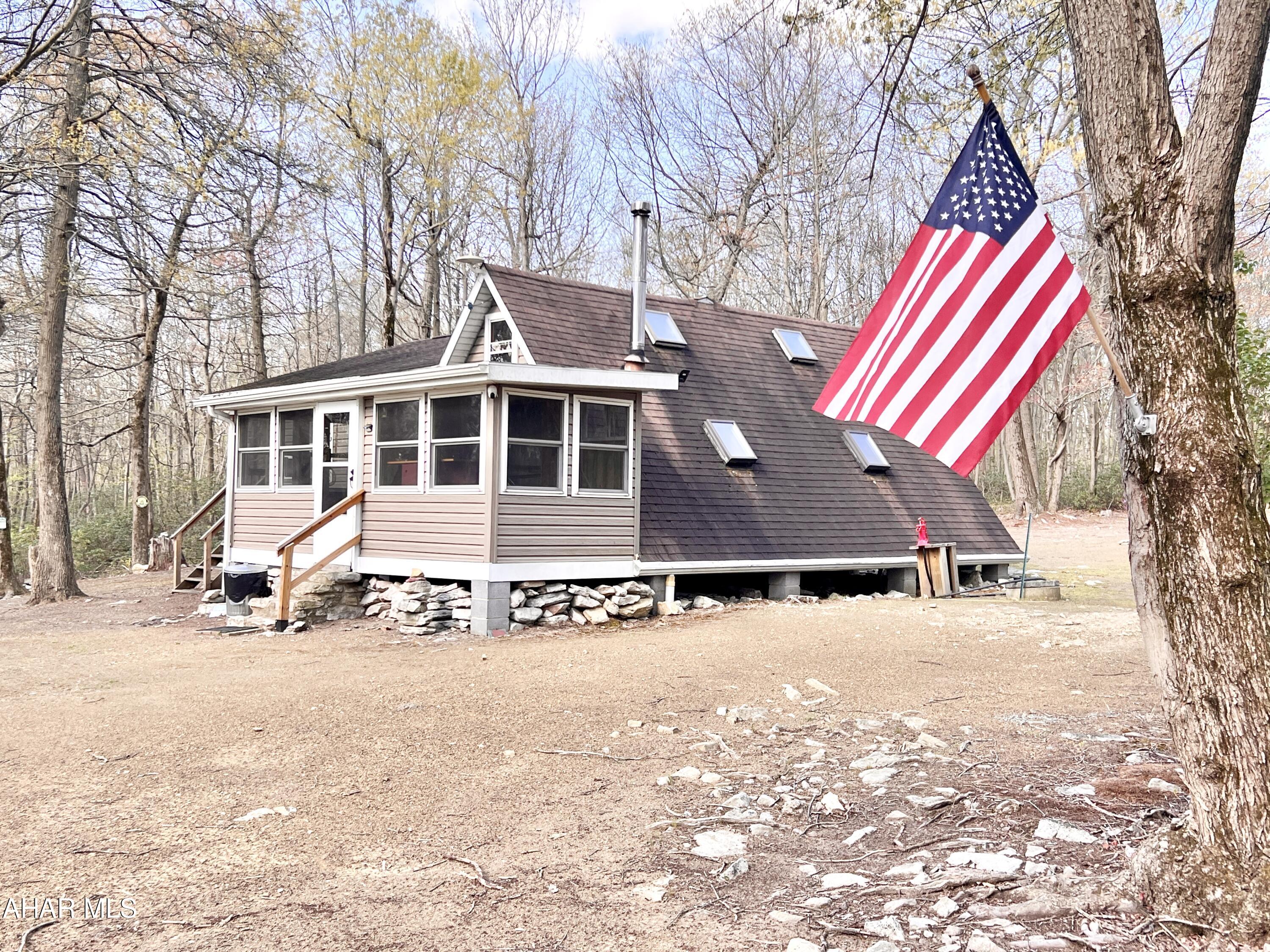 Secluded cabin resting on 10+/- acres located not far from PA State Game Lands.  Property offers a one bedroom cabin with Solar, Propane, and Generator hookups, cistern for water, privy, and multiple outbuildings. Would make a great hunting camp or getaway! No septic system currently on site and no electric is available on the Mountain, Seller uses Solar, generator, and Propane.