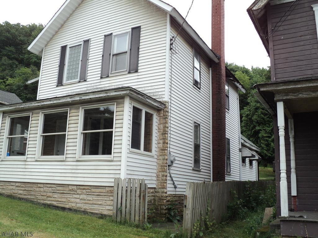 All taxes, square footage, and land quantities are estimated if unknown 0 is used.  Buyer to verify amounts. Newer carpet in carpeted rooms. Picture window appears to be double glass all other house windows except on enclosed porch are thermos  pane.  Fireplace functionality unknown.  Enclosed front porch.  Make a good investment property or first time home buyer.  Seller is selling house and property "as is" and will not be responsible for any repairs before or after closing,  The wooden walk way from the back yard to the patio at the rear of the house becomes very slippery when wet take caution when traversing same in wet weather.