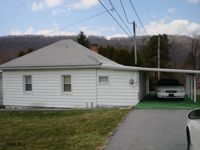 Cozy one bedroom one story with enclosed sun porch, and carport.