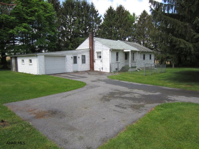 Nice 1 1/2 story, 3 bedroom, 2 full baths, 1 car attached garage sitting on 1.93 acres of country living.  Three storage sheds. Screened-in covered patio, recently updated kitchen.  Comes with appliances.  Bonus room on 2nd floor. Central Air.  A second residence is on property, a trailer with full length addition, with framed roof over trailer.  Ready to occupy and has it's own septic and electric systems.  Great for a rental.
