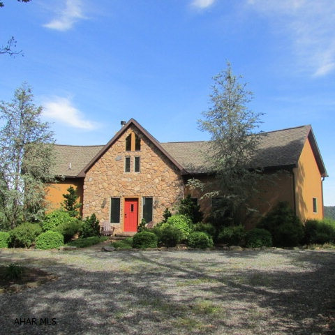 Incredible view of Lake Raystown and lots of character in this 3 Bedroom, 2.5 Bath home. The great room is angled at the front w/floor to ceiling windows & fabulous views of the lake. The second floor is open through the center with T&G pine on ceiling and an open staircase. The Dining area opens to the deck. Eat-in kitchen w/laundry area and door to the awesome firepit area. Downstairs has rec room & FR w/great views. Master BR & Bath are on the first floor. Also a half bath. Upstairs has two large bedrooms and a unique full bath. The home is big enough and also cozy. Heat pump with forced air.  Has gas fireplace & a woodstove. The driveway area is great - easy entrance & exit. Beautiful stone front & landscaping! 10 minutes to the launch!! Majority of furniture, linens, dishes convey.