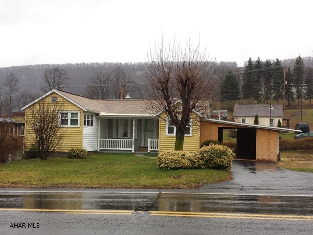 1 story, 2 bedroom home with modern kitchen and bathroom on large corner lot. Central air conditioning. Enclosed carport.