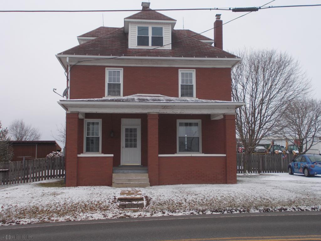 Super unique property in the cove! 4 bedroom, 1.5 bath brick home with original woodwork! Partially finished basement, new back sun porch, new dormers, new basement windows and the whole house just got all the brick re-pointed! The house has oil heat and also has wood burner in basement. Property has a 24x42 garage that is 100% finished on the inside! Radiant heat, its own septic, 1/4 bath, water, cable, phone/internet. Completely finished with drywall and oak trim! The ultimate (MAN CAVE).  So large, you could live in this garage! Property also has an outdoor furnace that is tied into the house and the garage; an economical way to heat! Behind the garage is a large garden already tilled and ready for planting season.