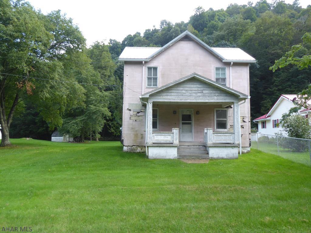 Situated at the foothills of the Southern Alleghany mountains, this home would be a great year round home or vacation home.  Short distance from Maryland, DC, or Pittsburgh.  With a little creativity and care, this home could be a beauty.  It has a nice flat yard that extends to the mountain.  The backyard has a stone fence for a historical country feel.  Sit back and watch the deer and wild life while listening to the sound of the trains and the WIlls Mountain Creek.  Motivated seller.  Home being sold as-is.