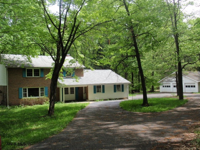 5.9 miles from Kettle Street and Pleasant Valley Boulevard, house is on the left.  Absolutely beautiful setting.  Good quality large home with hardwood floors.  Kitchen updated in 2004 with oak cabinet refacing.  Original baths dated to late 60's.  2 car attached garage, 3 car detached garage.  Recent survey indicates property adjoins State Game Lands.  Owner is looking for offers!