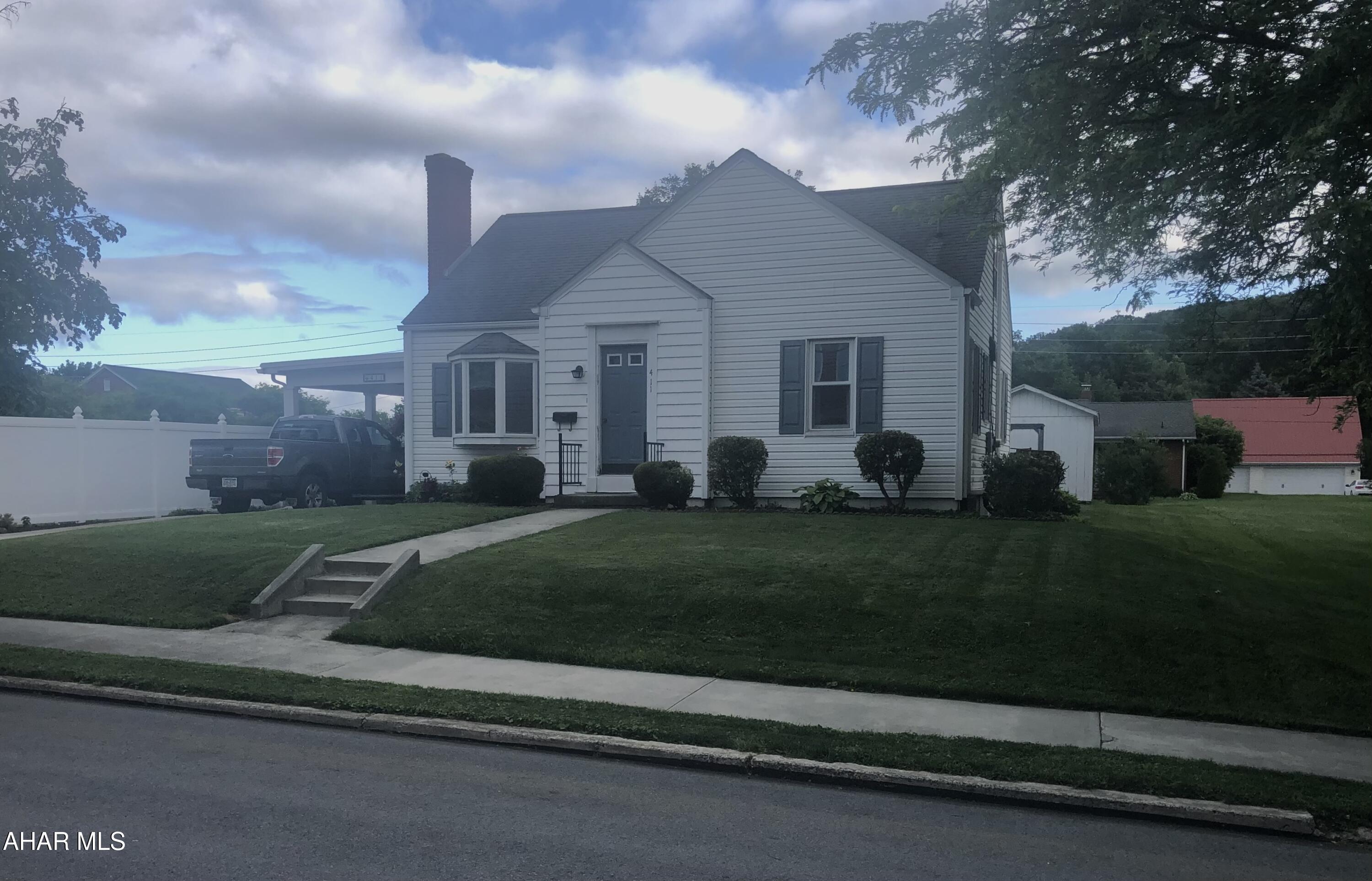 Hard to find in town home with oversized double car garage and fabulous carport. This walkable location is close to schools and shopping and is a must see!

Newer siding, roof and vinyl fencing provide ease of maintenance while seven mini split heating/cooling units provide exceptional energy eﬃciency.

Finding a garage in town that handles a truck and car is truly hard to find and this home does not disappoint with its abundance of space. Enjoy additional storage space with the large shed.

A lovely eat in kitchen with spacious dining space can be a place for entertaining guest and family. A main floor laundry room with large closets add tremendous convenience.

Carpeted areas have wood floors under them and removing the outdated carpets would add warmth and beauty to this home.  The upper floor could make an inviting master retreat with some  modern updates.

Don't wait, make an appointment to see this one soon!