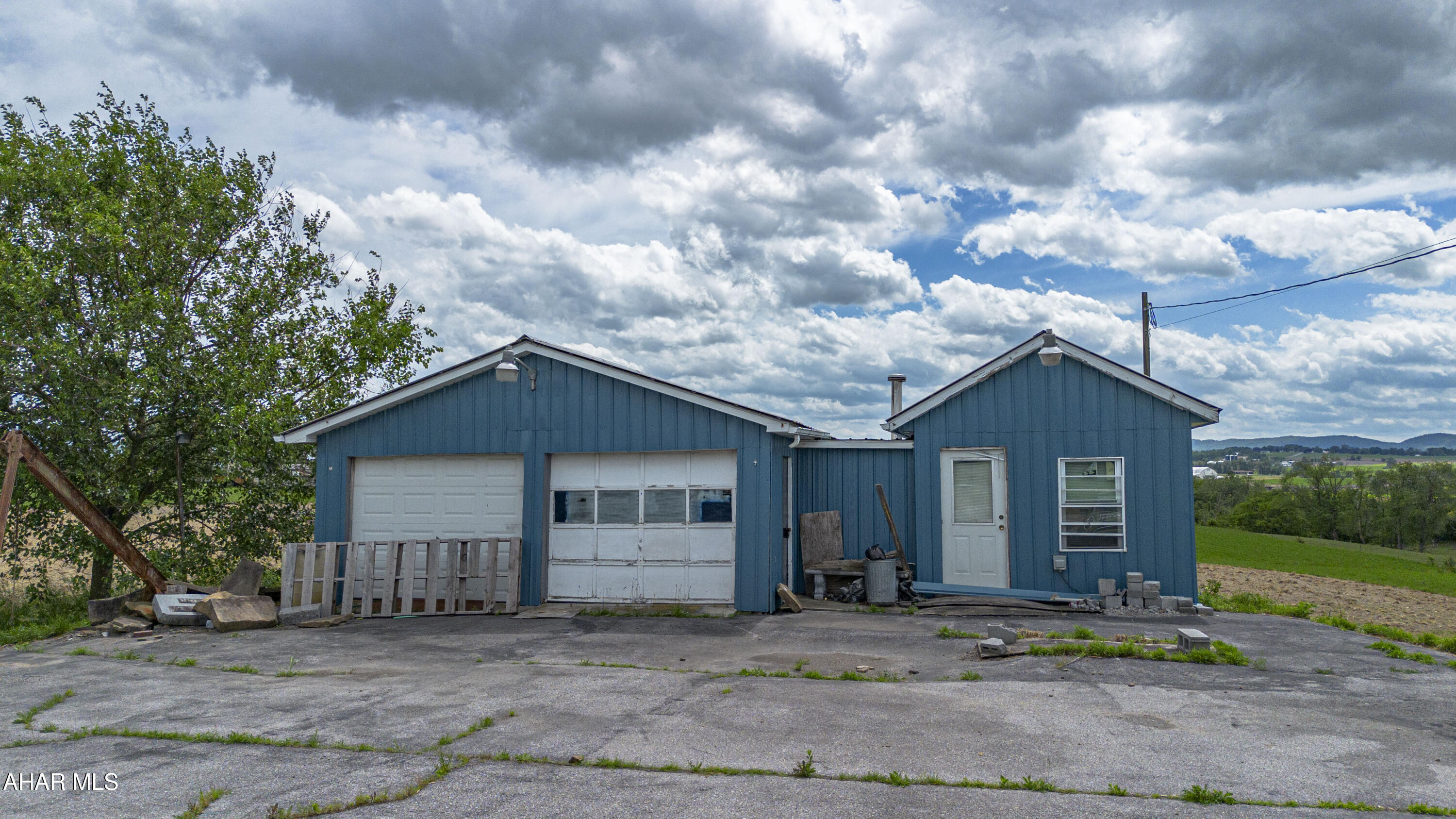 This commercial property features a garage and an attached office space, situated directly on a high-traffic highway for maximum visibility. The setup provides an excellent opportunity to open a small business, offering clear signage potential and easy access for customers. With dedicated workspace in the garage and a separate area to handle administrative tasks or greet clients, the property is highly adaptable for automotive services, retail, contracting, or specialized repair trades.