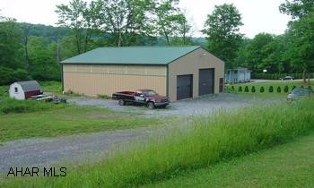 48x40 aluminum garage with car hoist. No well or sewage system. Call office for code.