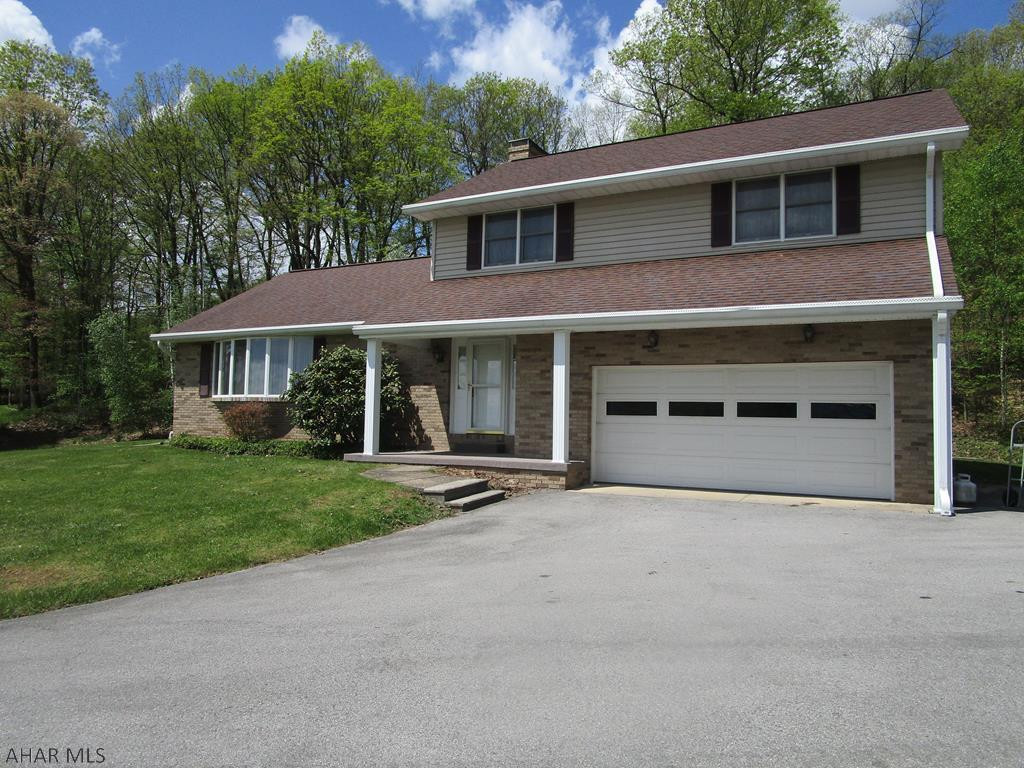 Well built two story on a dead end street in Juniata Gap area off Avalon Road.  Spacious living room with spectacular view, formal dining room,  Kitchen updated with breakfast bar.  Large bedrooms, three and 1/2 baths, 2 car garage.  Remodeled eat-in kitchen, beautiful wood paneled family room with hot tub and sky lights.  Laurie Lane is a dead end street off Avalon Road.  Quiet location with lots of wildlife.   Logan Township sewer which is on a four year pumping cycle.  Monthly sewer bill of $53.  Copy of Easement agreement and drawing for location of the sewer line available.  Newer Buderus boiler.