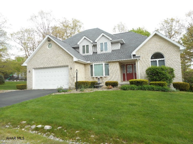 Sylvan East - This custom built home has 4 bedrms and 2.5 baths on a flat, wooded lot. Spacious and bright kitchen with oak cabinetry, solid surface counter tops,island and tile floor. Eating area overlooks the family room with gas fireplace and recessed lighting. Formal living and dining rooms. Convenient first floor laundry and powder room. Master suite features large walk-in closet,master bath w/ Jacuzzi tub, sep. shower and double bowl vanity. Walk-out basement has been pre-plumbed for bath. Spacious finished garage. New roof and hot water heaters. 2 zone heat. This home is conveniently located between Altoona and Hollidaysburg.