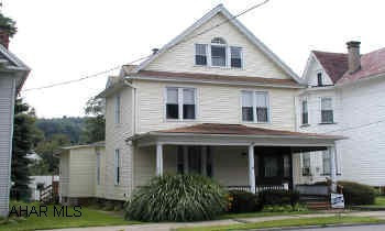 Nice large home 3 bedrooms, 2 baths, Hickory cabinets in kitchen, 2 car garage. Foyer with leaded glass doorway, naural woodwork, hardwood floors, appliances, gas HW heat with 2 zones, blown-in insulation, insulated windows, vinyl siding, deck, 2 car garage.