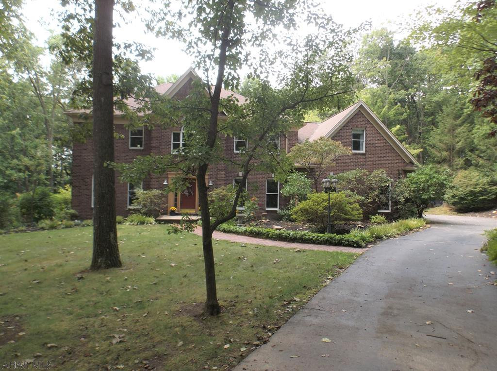 Stonehedge one owner, custom built 2 story brick situated on 1.01 acre.  4 spacious bedrooms, three and one half baths. Eat-in Kitchen with tons of cabinets,  granite countertops, center island & built in desk opens to a recently updated bright & sunny  familyroom with a brick FP, vaulted wood ceiling and hardwood floor. First floor laundry room, den/office, living room and formal dining room. Master BR with walk-in closet & master bath with jacuzzi tub, sep. shower & double sink. Sit out on the trex deck with Sunsetter awning and watch the wildlife in the back yard while relaxing. 2 furnaces and 2 Central A/C units. This is a one of a kind home!