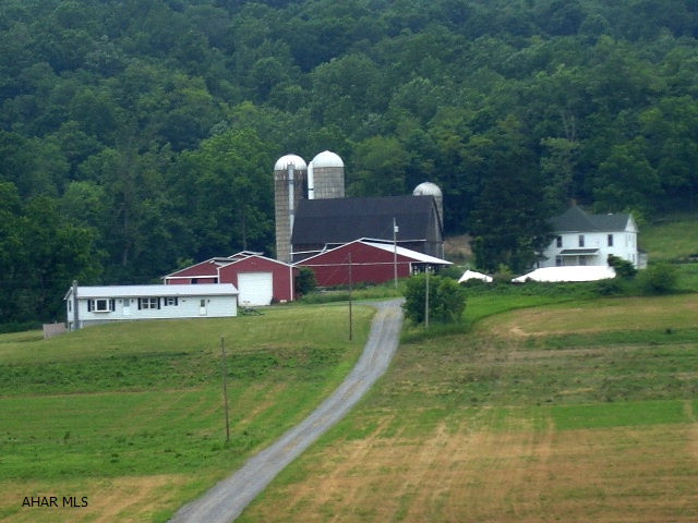 323+ total acres w/ 164+ tillable acres. Some fenced pasture, stream, spring water source. Borders state game land, not under any gas lease. All rights for gas and minerals convey to the buyer. There is no zoning in Monroe Township. There are two wooded sections on the property that are across the road from the main section w/ the buildings.