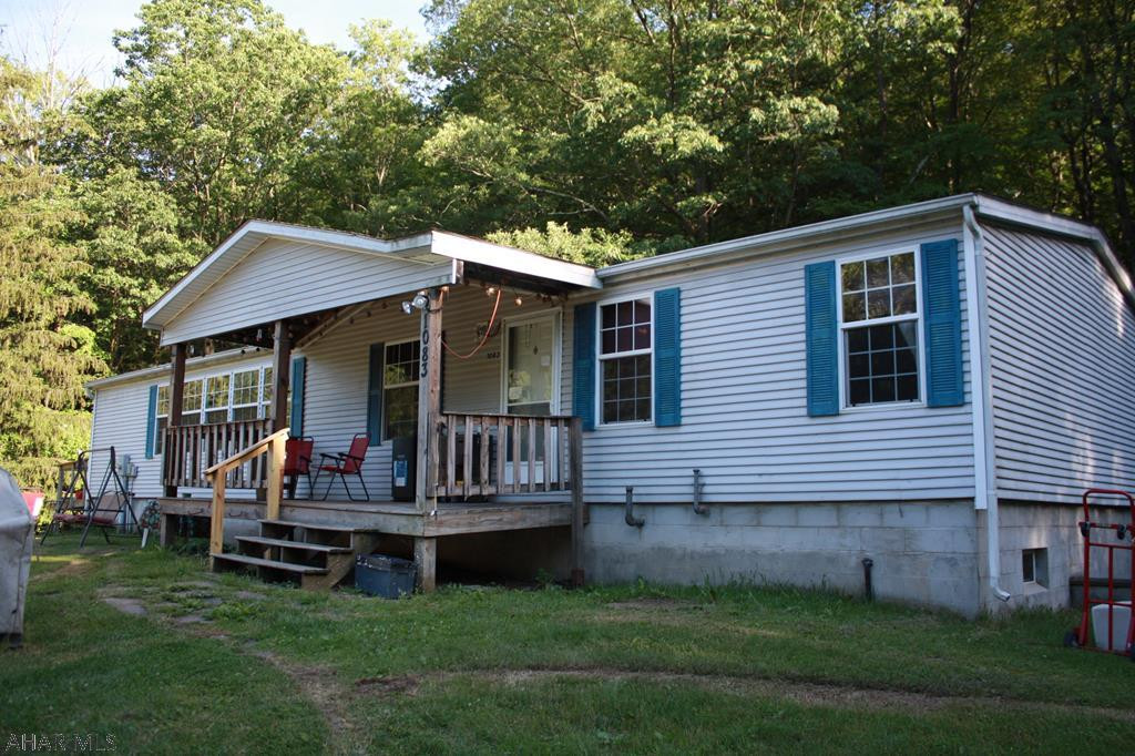 This property has 2.55 acres, and is a large doublewide on a full foundation.   4 Bedrooms and 2 Bathrooms.  The property has a large stream and the home sits back off the road in a quiet cozy woods area.  Check with your local Insurance Agent for flood information, the stream area is the flood zone the Home is not in the flood zone.