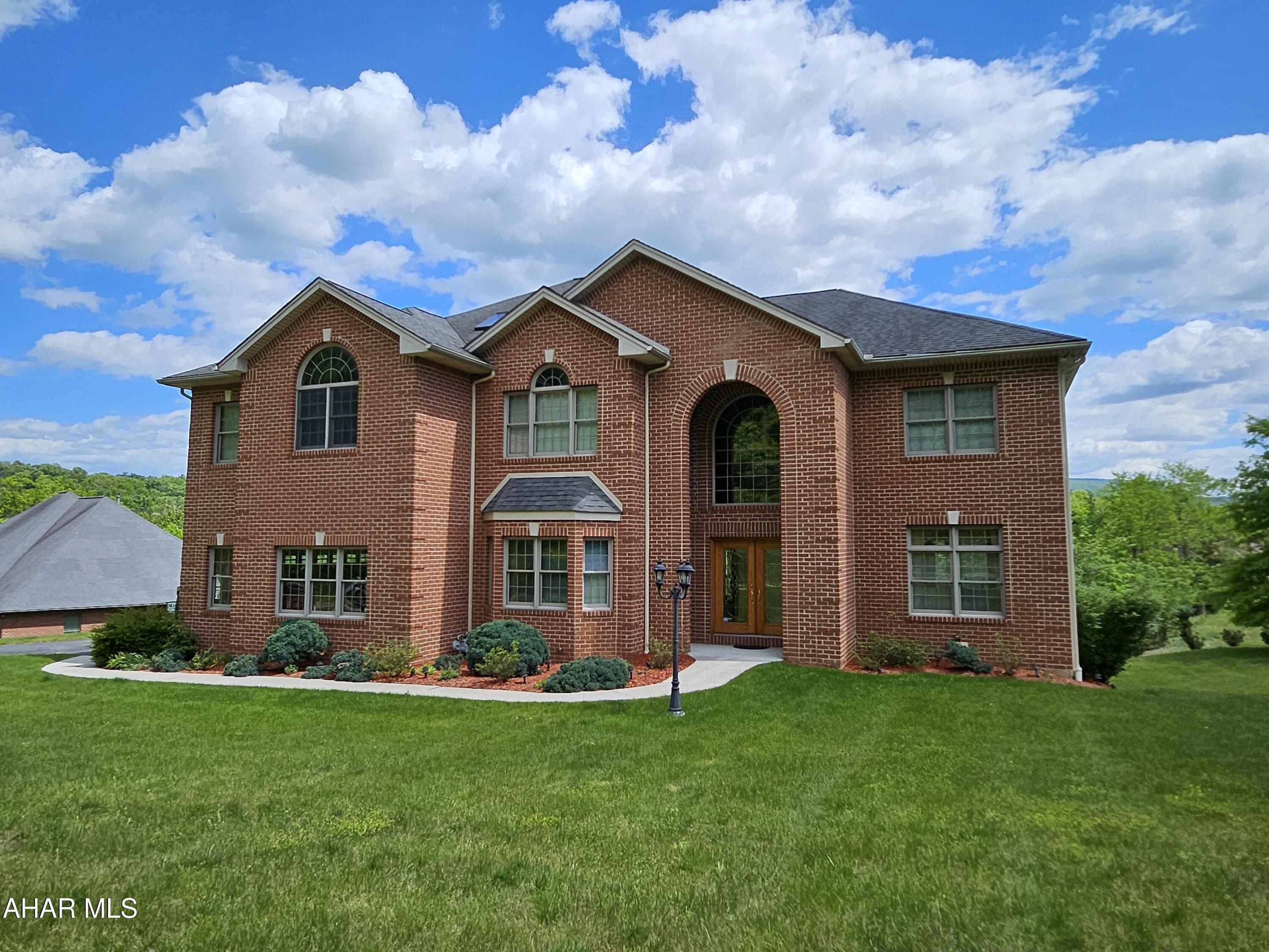 Experience luxury living in this thoughtfully designed residence featuring a dramatic two-story foyer, soaring ceilings, rich hardwood floors, and exceptional architectural detail throughout. Sun-filled living spaces include vaulted ceilings, skylights, bay windows, and a granite gas fireplace.

The gourmet kitchen showcases granite countertops, custom oak cabinetry, a signature piano-shaped island, walk-in and butler's pantries, and premium appliances designed for both elegance and function.

The luxurious owner's suite offers a spa-inspired bath, tray ceiling, and expansive walk-in closet, while the finished walkout lower level features a private theater, wet bar, full bath, and exceptional entertaining space.

Complete with whole-house audio, Andersen windows, three-zone HVAC, HEPA filtration, custom brickwork, and professional landscaping, this remarkable home blends timeless craftsmanship with modern comfort in an exceptional location.