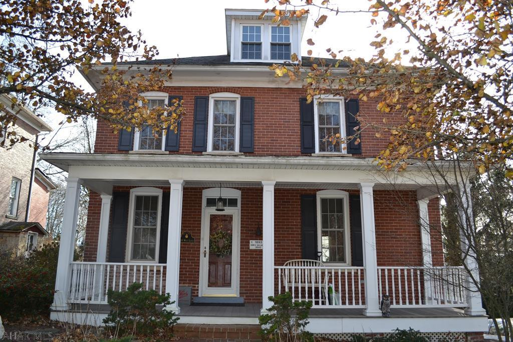Step into this beautifully redone turn of the century brick family home. This house has been thoughtfully redone through the many years. Owners have lived in this home since the 50's. Drywall, electrical, plumbing, and so much more has been redone. This home is beautiful. Gas fired fire place in warm living room, custom kitchen with granite counters, 1st floor laundry, off street parking, a block from down town shopping, events and courthouse. The property features 2 porches and a fenced yard with shed. Don't miss this beauty, just move right in! Ask about all the many features, too many to list!