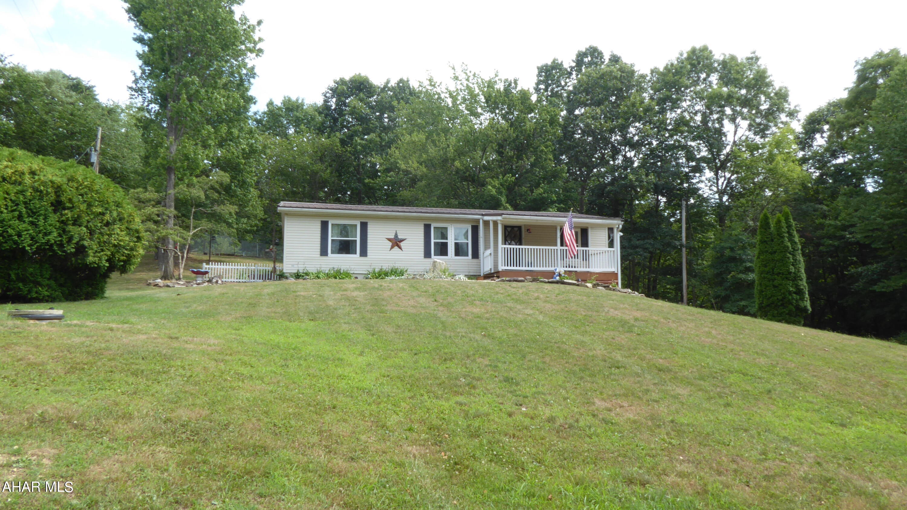 Location, location, location!  Short distance from Shy beaver boat launch and Raystown lake.  Situated on top of the mountain giving you privacy and serenity.  The property offers blueberry bushes, black raspberries, fruit trees, and so much more.  The back porch is perfect for watching the wildlife and birds.  Basement has bonus room for guests, game room, or craft space.  Complete with an integral garage.  Great for year round living or for a second home.