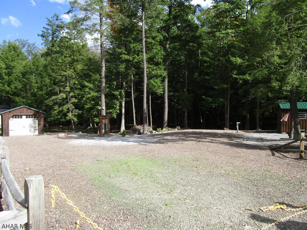 The Cadillac of campsites.  Spacious flat no maintenance campsite ready for your camper.  Large shed with garage door.  This lot backs up to the woods for privacy and deer watching.  City water is to the lot.  Sewer and electricity are on the lot.