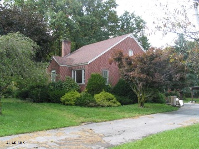 1.5 story brick home with large lot. 2 car garage plus carport. Hardwod floors.
