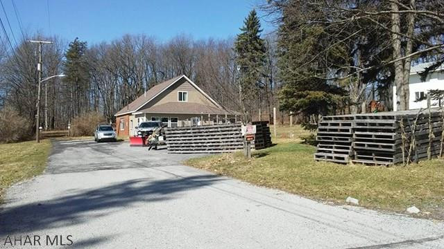 2 story 3 BR home with a large detached garage. New roof, new 2nd floor. Large open kitchen. Fireplace could be wood or gas. The 2+ bay garage has high ceilings & rear shop area. 1900 sq ft.  New overhead doors, newer roof, 1/2 bath and 6" cement floor