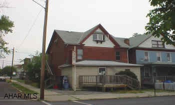 Brick corner store or office with 2 apartments overhead, 2 furnaces, separate electric, apartments in good condition.