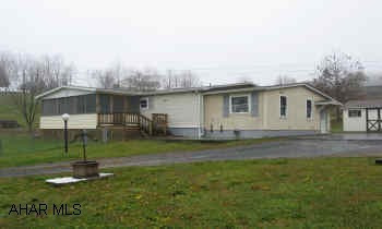 3BR/2BA Shuttered Double wide in nice location. Enclosed deck, vinyl siding, 2 outbuildings.  Finished room in basement. Immediately available. Home Warranty Included