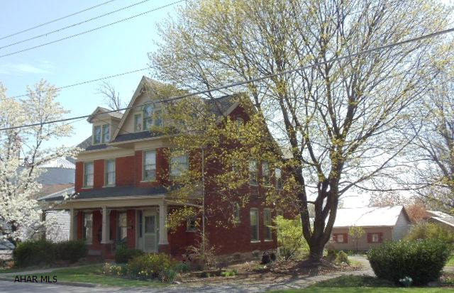 Beautiful 2-story brick home, hardwood floors, pocket doors, family room, 2 Interior Staircases, 1st floor bath w/jacuzzu tub, enclosed side porch, newer furnace, 4-room workshop, & 2-car detached garage.  #J-124