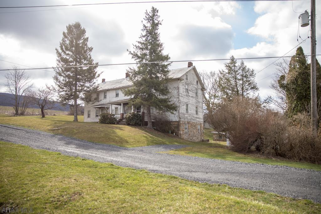 This property offers 58.285 acres of rolling fields and woods, city sewer and spring water on site.  Large two-story house in need of repairs and updates.  Detached two-car garage and block milk house.  Road frontage along Meadow Road and Bob's Creek Road.
