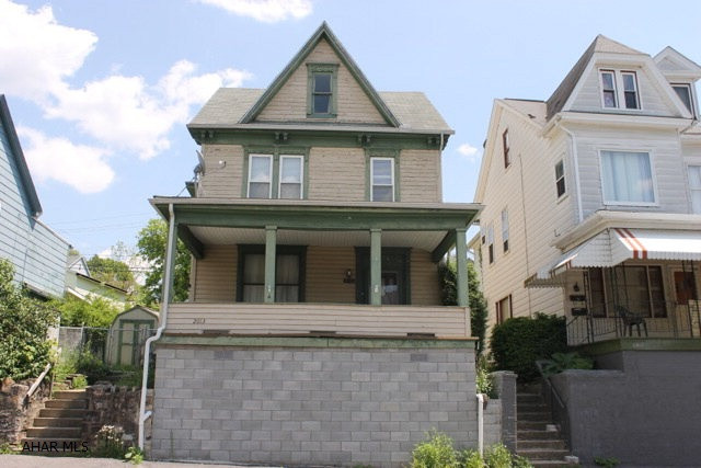 Great starter home walking distance to schools. The 1st floor large rooms with all natural woodwork throughout. There are pocket doors leading into the dining room with vent-less gas fireplace, and bonus room which is currently used as the laundry area. Beautiful staircase leads to 3 large bedrooms, sitting area and a walk-up attic that could be finished for additional bedroom or plenty of storage. Off street parking and fenced yard.