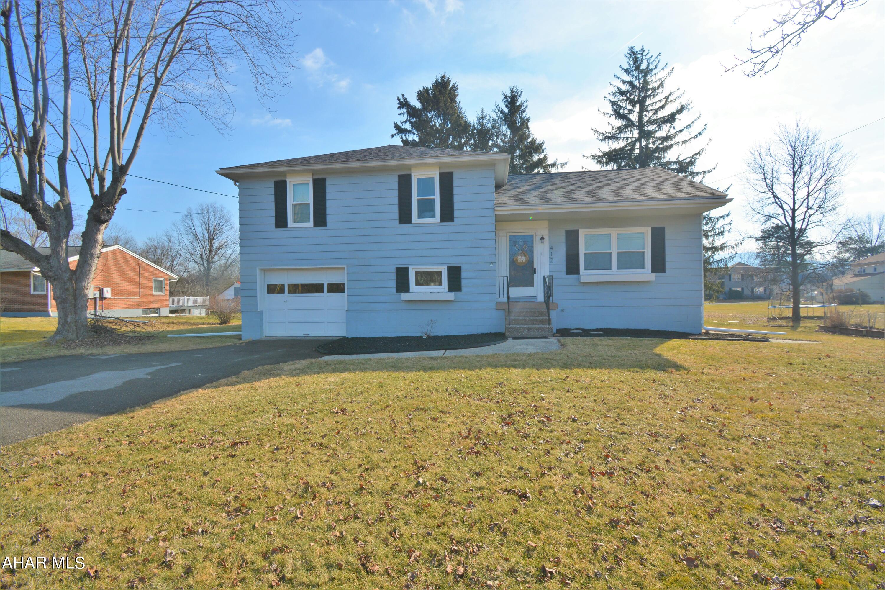 --OPEN HOUSE SUN 2/19 12:30-2PM🎈-- Marvelous Multi-Level in Hollidaysburg School District!  This 3 Bedroom, 2 Bath home is cute as a button & Ready for Y-O-U!  Upon entry from the front you will find yourself in the formal living room with hardwood floors & nice natural light.  This flows right into the UPDATED kitchen with nice counters, ceramic tile floors & SS appliances.  It's an easy trip down a few stairs to the lower level which has a Family Room & 3/4 bath, each with vinyl plank floors.  You can also access the single car garage & backyard from this level.  Below this is the basement with utilities & plenty of room for storage.  Upstairs are the 3 bedrooms, each with hardwood floors and the super sweet full bath with tile surround & built in shelving. There are two closets up here with one giving access to the attic which is great for storage too.  This all sits on  .24 acre in Hollidaysburg Borough with a nice backyard that is sure to please this summer!   Home has a newer heat pump so AC for the upcoming summer months is covered too.  Call today to set up your showing!