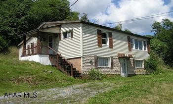 Attractive raised ranch vinyl styling. 2BR/1BA, large eat-in kitchen, walk-out basement. OFFERED AS-IS Cement block garage, some thermo pane windows. Easy access with lock box, storm windows and doors.