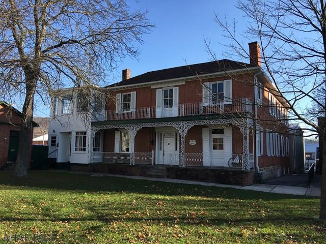 This Prestigious McCauslin Mansion is a  6 Multi-Unit Apt. Complex is within our Historic District.  Each unit is individual and unique, offering history and charm. The decorative veranda and porches adds to the character and history of the McCauslin Mansion built in the1800's.. The exterior trim has been recently painted and the roof was replaced 10 years ago. Located in the town center square with easy walking access to all shops and restaurants.  There is a 30x40 garage adjacent to the apartment building with a 12x20 storage area. Each unit has its own electric box and natural gas is the heat source.