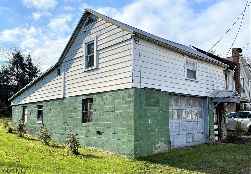 A unique opportunity in Historic downtown Bedford.   1092 sq foot main floor garage to park multiple cars, storage and more.   Second floor is the perfect efficiency apartment with one full bedroom and two 3/4 bathrooms, full kitchen and in-unit laundry.