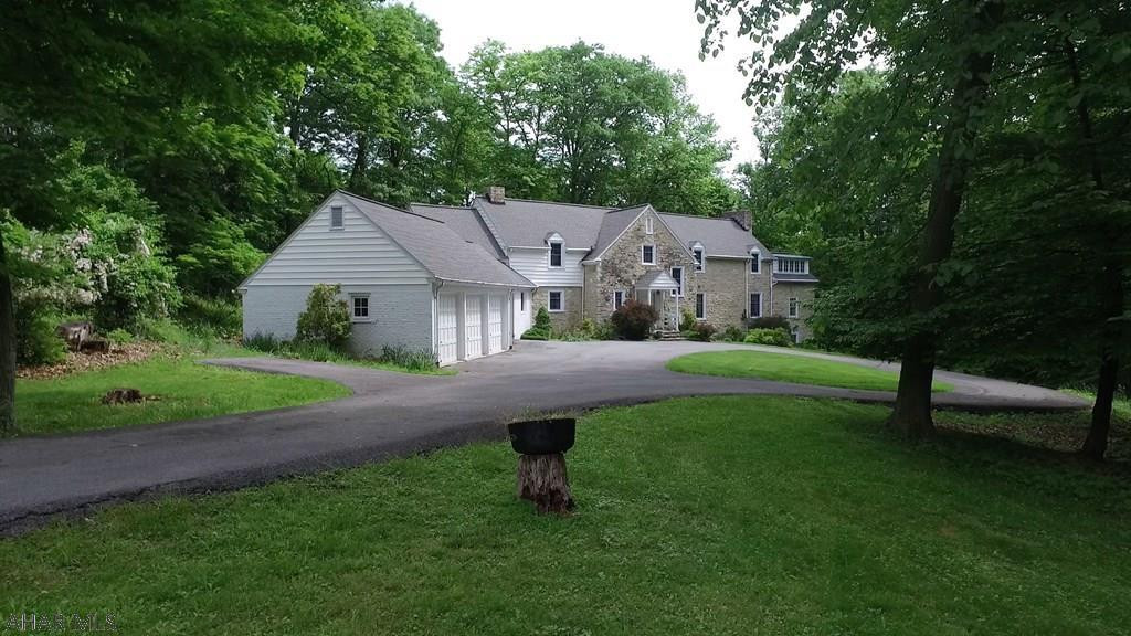 This stunning stone mansion w/ 7.5+/-private acres w/3 car garage is nestled in the woods in one of Bedford's most sought after locations. Hallmark features of this home & stunning views are sure to impress the most discriminating buyer. This Georgian style architecture has been consistently admired for its impressive appeal. Natural gas, extra insulation & energy efficient windows ensure maximum heat savings.  Stately home w/servant's quarter, formal living & dining rooms & kitchen with butler's pantry. 2nd level includes a master wing w/fireplace complete w/master bathroom, dressing and sitting rooms. Another master suite + two additional bedrooms, huge walk in closets are also found on the upper level. .  Adjacent to Omni Bedford Springs. Drone video attached.