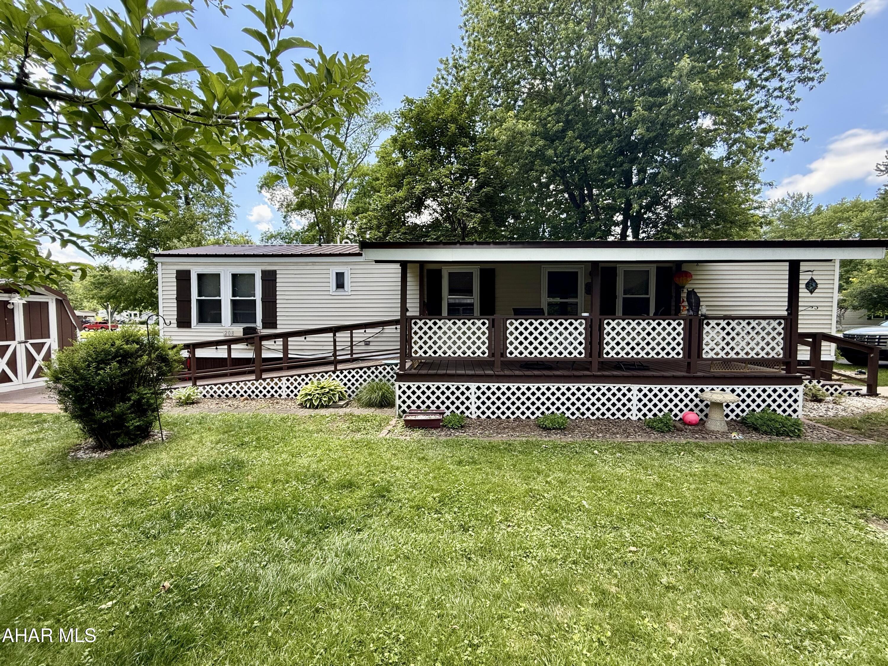 Great mobile home is move-in ready and situated on a great lot in the 'over 55' community of Friendship Village. Relax on the expansive covered porch and handicap accessible ramp leading to a scenic fishing pond right in your own back yard! Or enjoy an evening entertaining around your firepit! This well-kept home has lovely landscaping, with newer roof, washer/dryer, furnace and flooring. Friendship Village offers activities within walking distance for your personal enjoyment: swimming pools, miniature golf, walking trails, camp store, and lots of fun events. Buyer must make application and be approved by Friendship Village prior to transfer of title.