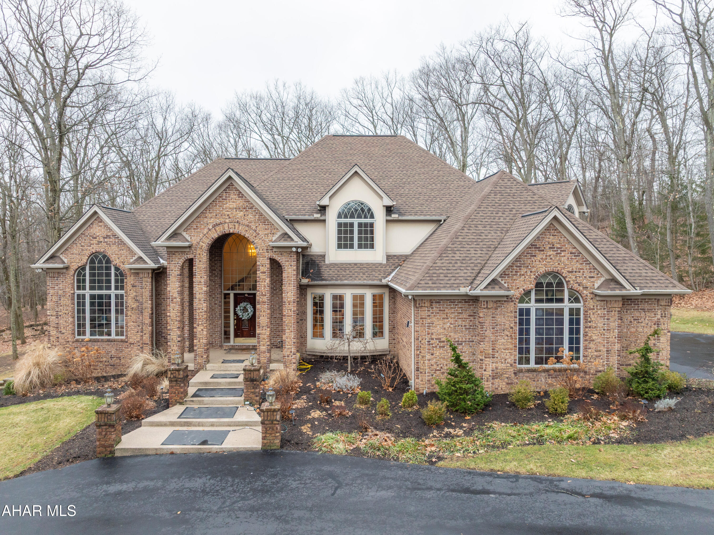 Experience refined luxury in this stunning four-bedroom, six-bathroom estate set on 2.27 private acres. Designed with elegance and comfort in mind, the home features a spacious open floor plan that seamlessly connects living, dining, and entertaining spaces, all filled with natural light. The gourmet kitchen showcases sleek quartz countertops, high-end finishes, and ample room for gatherings both large and intimate.
Each bedroom offers generous space and privacy, each with its own en-suite full Bath, thoughtfully appointed with upscale fixtures and modern design.
The finished basement adds exceptional versatility—ideal for a media room, home gym, or additional living space. A spacious four-season room with a cozy fireplace provides the perfect place to relax and enjoy the surrounding views year-round. 
Additional highlights include a Four Car Garage with a pull down storage space, central air conditioning, a whole-house generator for peace of mind, and expansive outdoor space that enhances the home's sense of privacy and tranquility. This remarkable property blends luxury, functionality, and comfort in a truly exceptional setting. ***ALL OFFERS MUST BE SUBMITTED BY SUNDAY 1/11 AT 11am PLEASE***