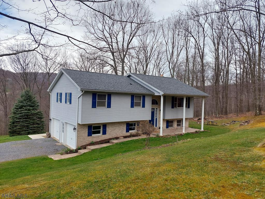 Desirable family home with seclusion in the HASD. This home has an exceptional amount of outdoor space sitting on 1.09 acres, including a 30x40 detached garage with 12 foot doors and another 2 car attached garage. 2 spacious bedrooms with full baths attached to both. Open kitchen to dining room and family room. Walk out onto your deck from your dining room and enjoy the tranquil view of mountains and wildlife. Large family room with wood stove in basement, or use as an additional bedroom. Many updates include sidewalks, appliances, A/C, hot water tank, roof, and more.