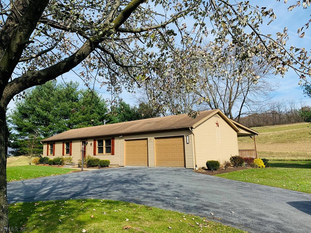 Enjoy one story living while relaxing on this large covered porch overlooking lovely views.  A circular driveway adds to the lovely curb appeal of this home.  Enjoy the convenience of a main floor laundry room, master bedroom with private 1/2 bath and large eat in kitchen.  This home has been meticulously maintained throughout and is move in ready.  Add the convenience of an attached double car garage and finished lower level and you have a home that will not last long.