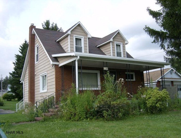 3 BR 1 1/2 story brick & aluminum sided home. 2 car detached garage