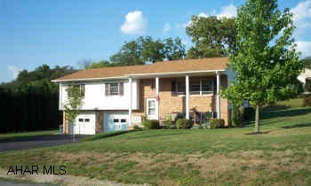 Beautiful brick & vinyl home in Rolling Hills. Home features central air, oak kitchen, and large deck w/hot tub. Nicely landscaped lot features garden, electric dog fence, and apple tree. Cheap to heat and cool too! Relocation addendum required with offer.