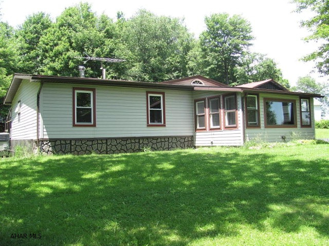 Central Cambria schools- doublewide with additions on 6 acres. 3 car detached garage & familyroom. Florida room with hot tub.